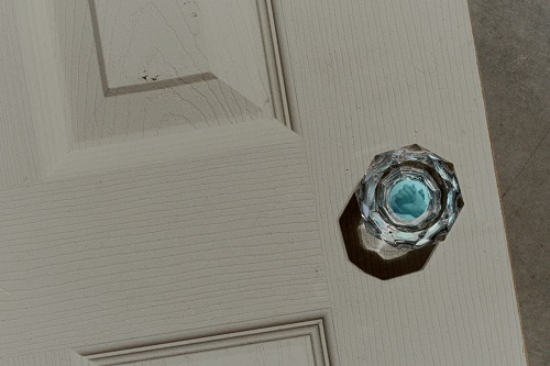 A. M. HOCH, Mitosis: Formation of Daughter Cells, DETAIL: door on the floor with glass doorknob with embedded video, 2004