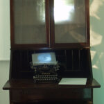 A. M. HOCH, interstices, DETAIL: armoire with embedded camera obscura reflecting the outside lawn and harbor, and typewriter with embedded video; 76 inches x 43 inches x 25 inches, 2002