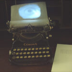 A. M. HOCH, interstices, DETAIL: typewriter with video loop of blinking eye projected onto page