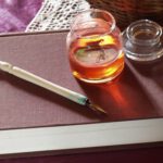 A. M. HOCH, interstices, DETAIL: ink bottle with embedded video of woman riding a bicycle in circles; approximately 2.25 inches in diameter; 2002